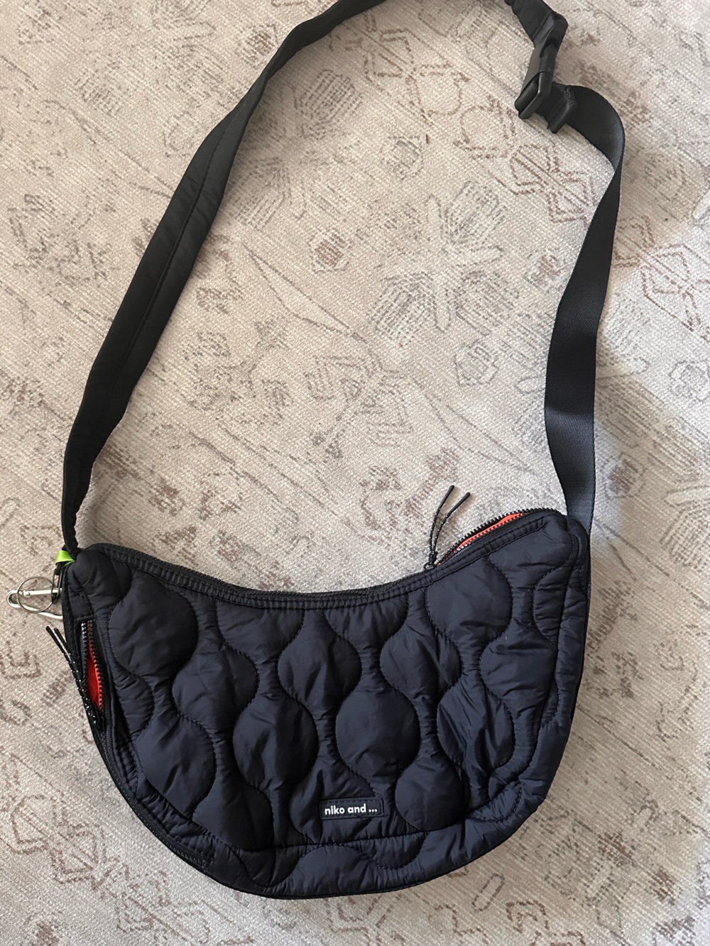 Quilted Black Crossbody Bag with Red Zipper Detail